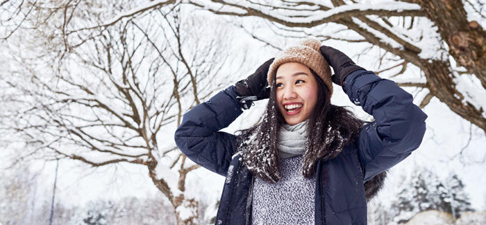 Student playing in the snow